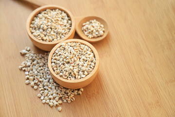 Fresh organic millet or job's tear seed on sack in bowl  in kitchen for cooking in daily life meal. selective focus. top view.