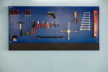 Arranged tools on the board at mechanic shop.