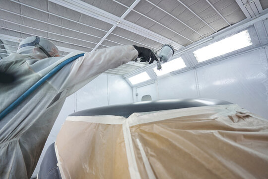Close-up photo of car painter work process in workshop