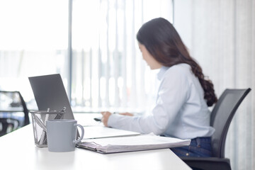 Blurred image of a businesswoman, Asian businesswoman using laptop to private office at home, Freelancers work, Online communication, VDO Call , Home lifestyle.