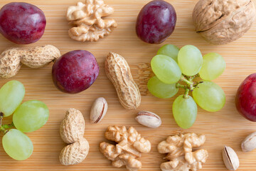 Fototapeta na wymiar nuts and fruits on wooden background