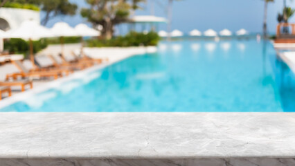 Empty white marble stone table top and blurred swimming pool in tropical resort in summer banner background - can used for display or montage your products. - obrazy, fototapety, plakaty