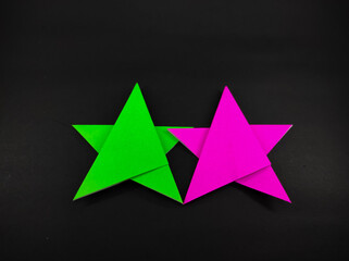 Abstract Defocused Two-colored star made of origami paper isolated on black background