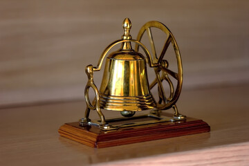 Fototapeta na wymiar Office Brass Table Bell With Wooden Base