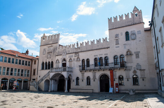 Old house with battlements and two towers on the main square of the port city of Koper in Slovenia.