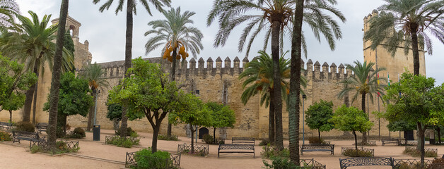 Exterior panoramic view at the Alcázar of the Christian Monarchs fortress or Alcázar of Córdoba, a medieval alcázar located in the historic centre of Córdoba, Spain - obrazy, fototapety, plakaty