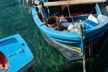 Fototapeta na wymiar Fisherman's boat parked at the shore on water