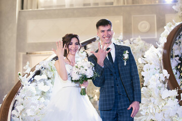 Happy family of the bride and groom at the ceremony on the wedding day show their hands with rings