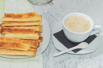 Fresh pastries and a white cup of coffee