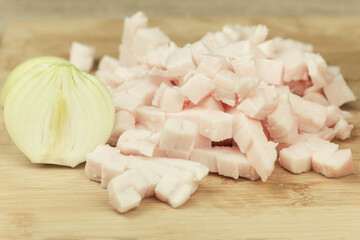 Fresh and raw lard finely chopped, meat on a cutting board