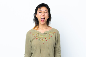Young Uruguayan girl over isolated white background shouting to the front with mouth wide open