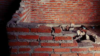 Close-up of the rubble of an industrial building collapsing into a pile of concrete and brick. and...