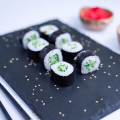 Sushi Maki rolls cucumber. Fresh hosomaki pieces with rice and nori. Close Up of delicious japanese food with sushi roll.
