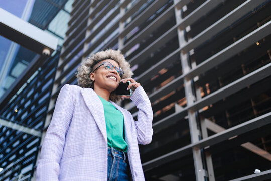 Confident Cool Black Business Woman Talking On The Phone Outside A Modern Building. Young Female Professional On A Call.