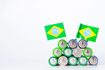 Battery. A lot of batteries on the background of the flag of the country.