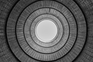 Cooling tower of a public accessible power station, view from bottom to top in monochrome