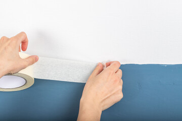 masking tape stands on a white background. adhesive paint protection tape. Painters and people who...