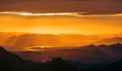 Beautiful landscape of a sunset with an entrance of light rays between the clouds.