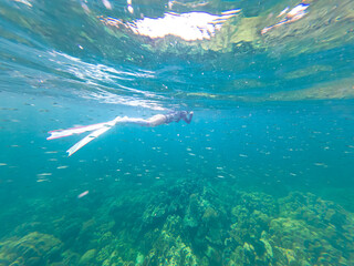 Happy lifestyle young woman in a swimsuit Snorkeling and swimming underwater in tropical sea