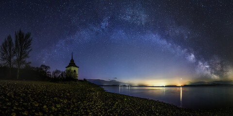 Milky Way over the Church of the Virgin Mary at Liptovska Mara, beautiful Slovak unspoilt nature, a wonderful destination for vacation and relaxation