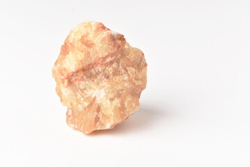 One  uncut and rough Sunstone crystal,quartz on white