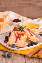 Lemon pund cake with blueberries and strawberry syrup.