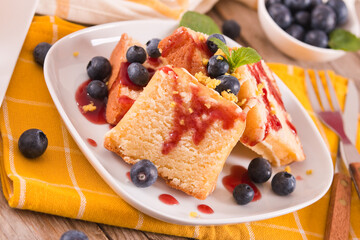 Lemon pund cake with blueberries and strawberry syrup.
