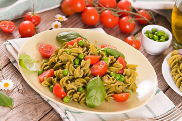 Fusilli pasta with cherry tomatoes and peas.
