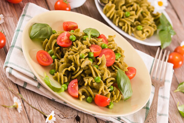 Fusilli pasta with cherry tomatoes and peas.
