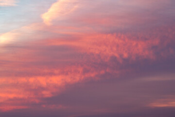 Naklejka na ściany i meble Purple and orange clouds at sunset. 