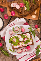 Rye bread with cottage cheese, radish and arugula.