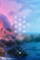 Flower of life - the interlocking circles ancient symbol in front of blurry photo background.