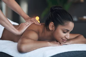 Fotobehang The best days are spa days. Shot of a young woman getting a back massage at a spa. © Nicholas Felix/peopleimages.com