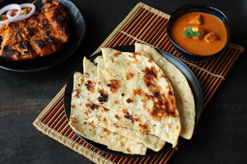 Tandoori Roti whole wheat flat bread with Indian curry butter chicken and butter paneer . Indian...