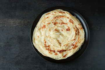 Kerala parathas / porotta / roti / parotta / barotta/ naan layered flatbread made from maida or whole wheat flour. Eat with spicy Asian chicken or beef or egg curry gravy. breakfast dish. Indian food.