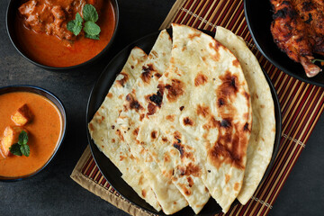 Tandoori Roti whole wheat flat bread with Indian curry butter chicken and butter paneer . Indian roti or chapati 