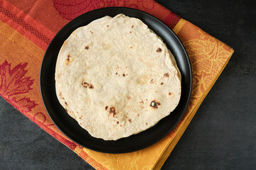 Roti paratha porotta parantha chapati Indian flatbread made of whole wheat atta flour side dish Butter chicken curry naan Delhi North India  Chicken tikka jalfrezi Punjabi dhaba chicken curry masala
