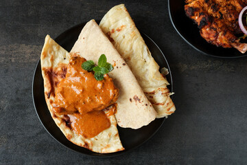 Butter chicken curry with naan Murg Makhanwala roti paratha porotta parantha Indian flatbread cuisine Delhi India Murgh makhani chicken cream  Chicken tikka jalfrezi Punjabi dhaba chicken curry masala