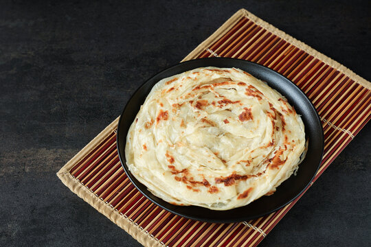 Kerala parathas / porotta / roti / parotta / barotta/ naan layered flatbread made from maida or whole wheat flour. Eat with spicy Asian chicken or beef or egg curry gravy. breakfast dish. Indian food.