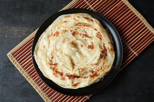 Kerala parathas / porotta / roti / parotta / barotta/ naan layered flatbread made from maida or whole wheat flour. Eat with spicy Asian chicken or beef or egg curry gravy. breakfast dish. Indian food.
