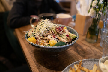 Vegan Buddha bowl with tempeh, courgette, sundried tomatoes and sprouts
