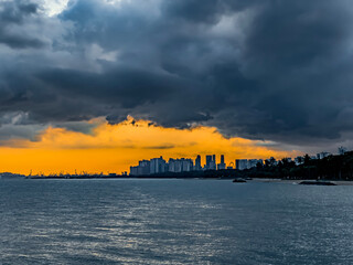Sunset with a passing dark cloud over the Singapore Skyline