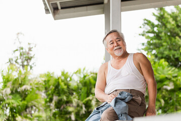 Senior Asian man sitting relax on the terrace, Asian family concepts