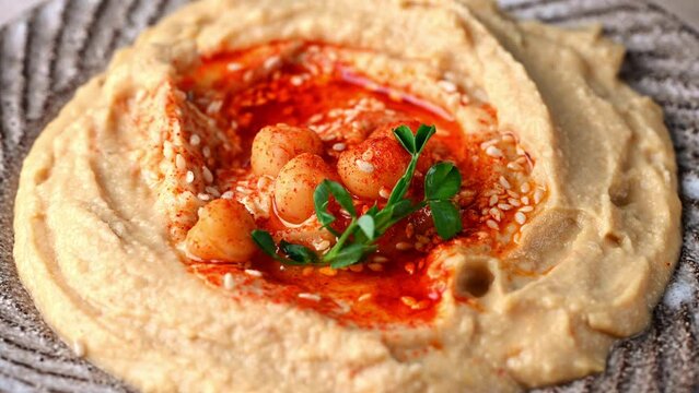 hummus with sesame and olive oil close up. Healthy vegan food. Hummus rotation. Vegetarian dish. Mezze chickpeas. Kosher food.