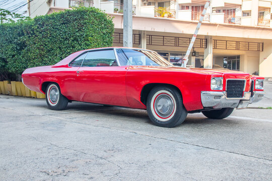 an American classic car in a parking lot in the city