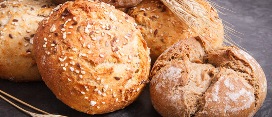 Wholegrain rolls or bread for breakfast and ears of rye or wheat grain