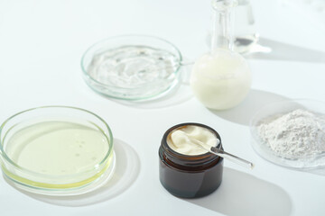 petri dishes with medium and glassware on a laboratory table. fermentation, fermented beauty skin care. container with cream or solution or serum for anti age treatment developed in a lab
