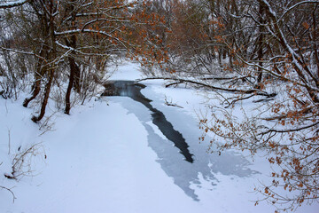 Photo of a snow-covered river covered with ice