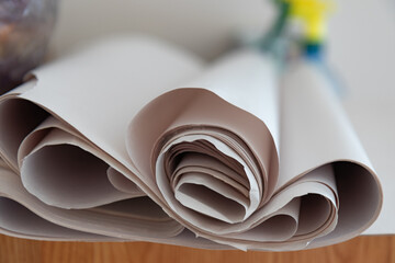 paper roll. curled beige material close up. cardboard production concept