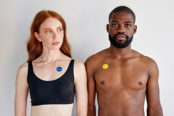 vaccinated couple during coronavirus and flu outbreak. Virus and illness protection, quarantine. COVID-2019. isolated over white studio background. portrait of black shirtless guy and redhead lady